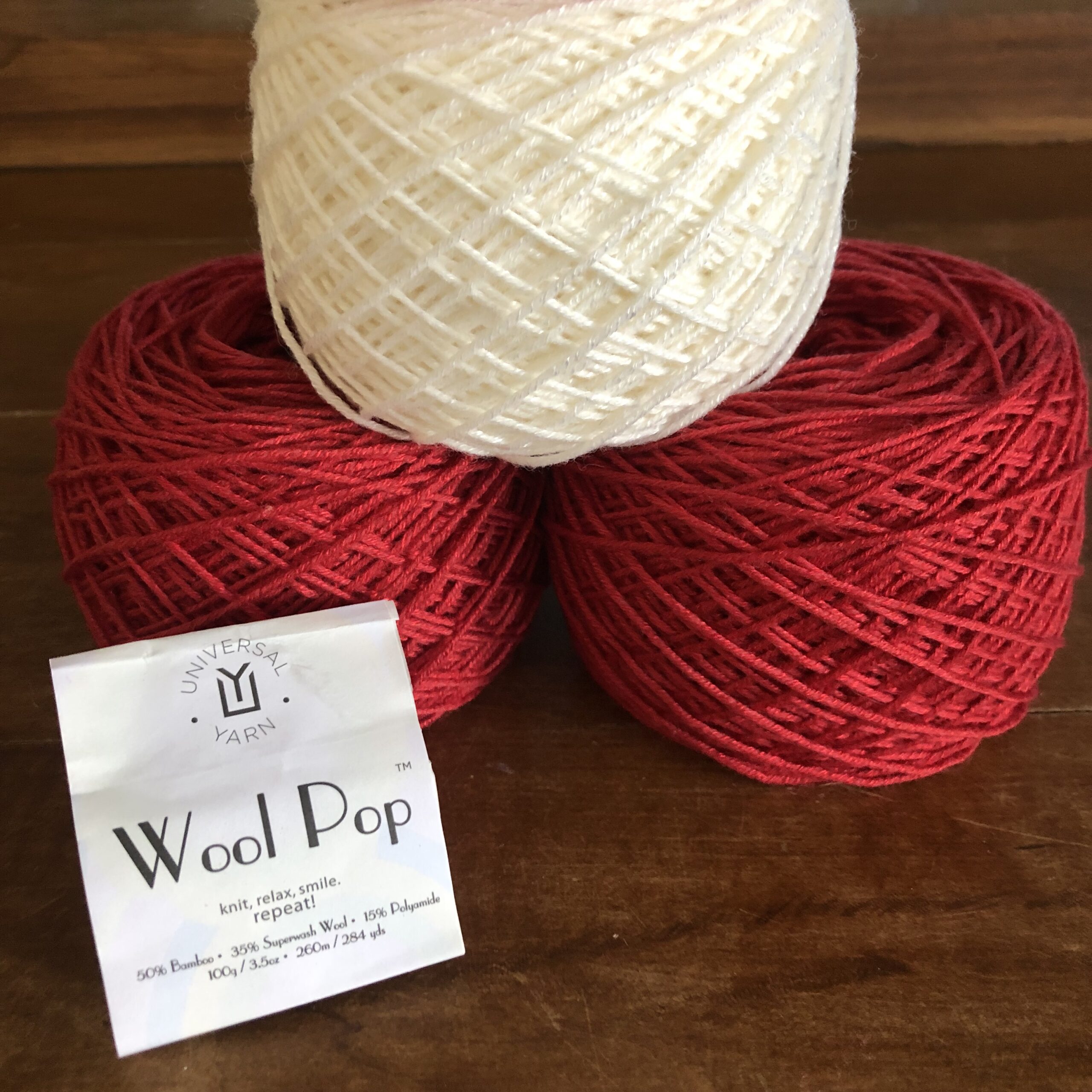 red and white wool pop from universal yarn